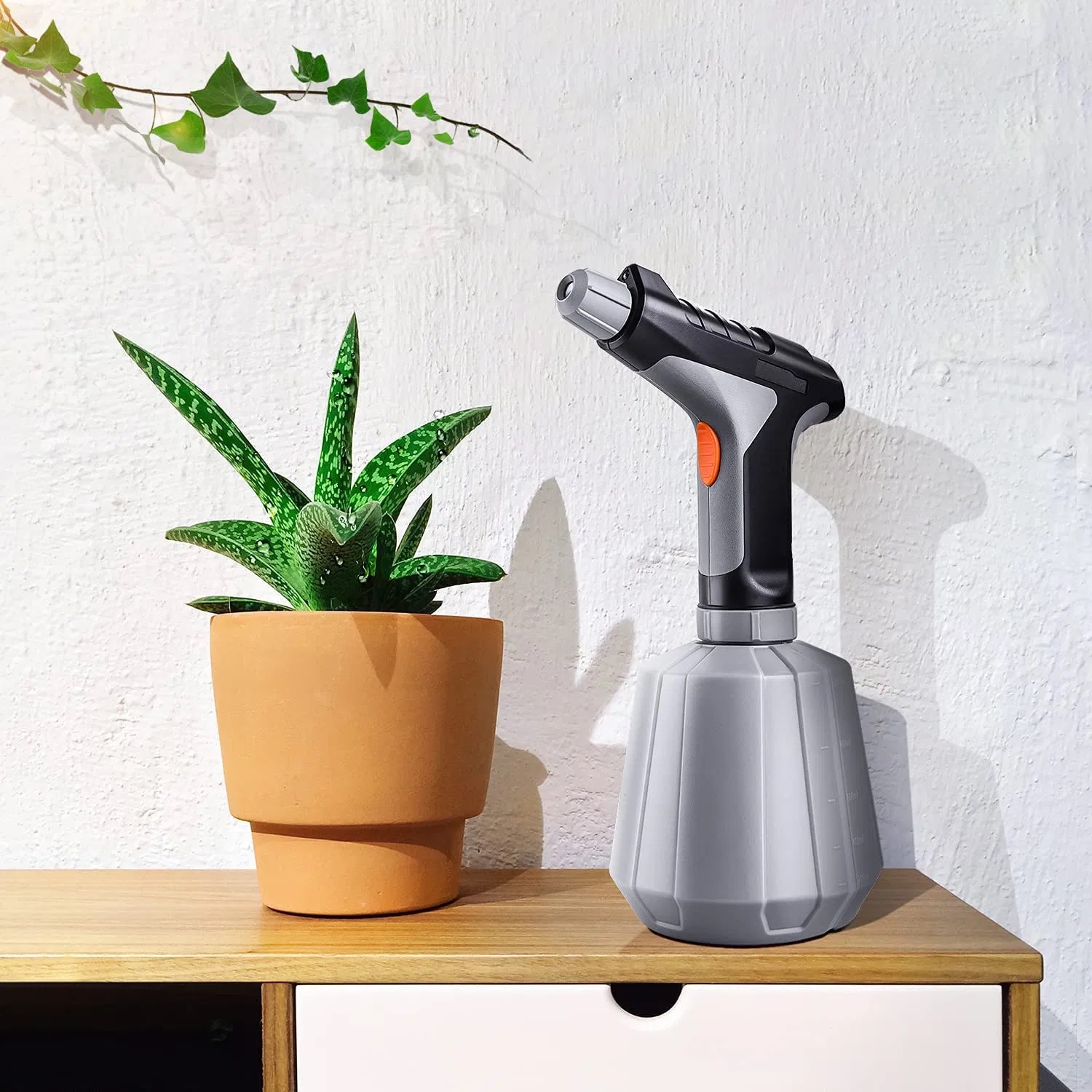 1 litre USB electric garden sprayer beside a potted plant